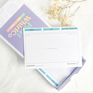 May include: A lilac box with the text "Pixel Whirlco" in colourful letters. Inside the box is a white card with sections for subject, topic, and other notes. The box is open, revealing the card and its contents.