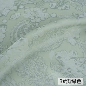 May include: A light sage green fabric featuring a tonal jacquard weave with intricate floral and paisley patterns. The material has a subtle sheen and a textured surface, with the text 3#浅绿色 visible in the bottom right corner of the image.