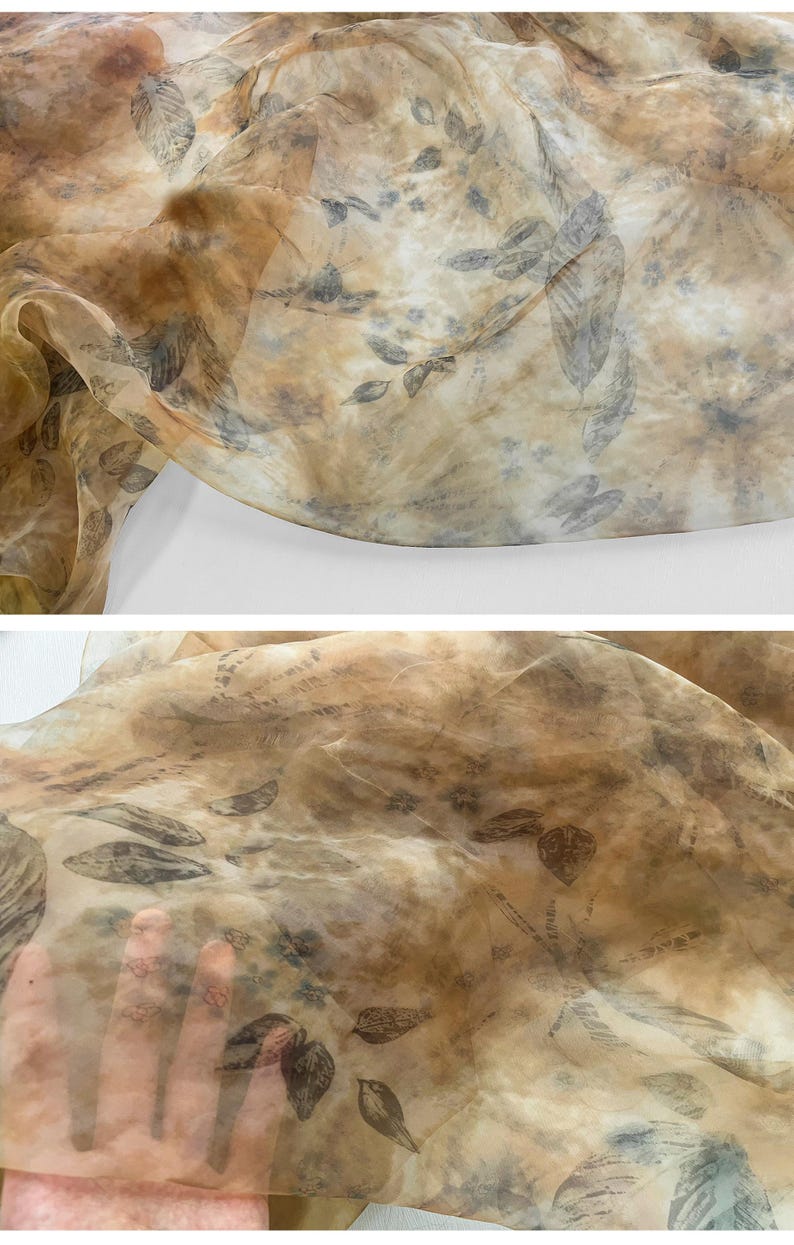 May include: A sheer fabric with a brown and beige background and a leaf pattern printed on it. The fabric is translucent and has a soft, flowing texture.
