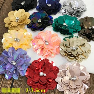 May include: Assortment of 10 colorful sequin flower embellishments with a rhinestone center. Each flower measures 7.75 inches in diameter.