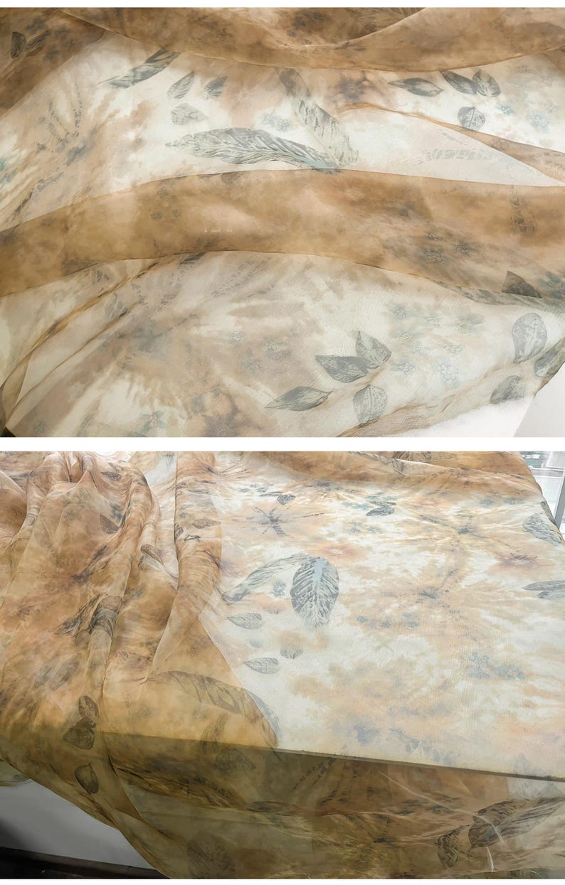 May include: A sheer fabric with a brown and white background and a leaf pattern. The fabric is translucent and has a soft, flowing texture.