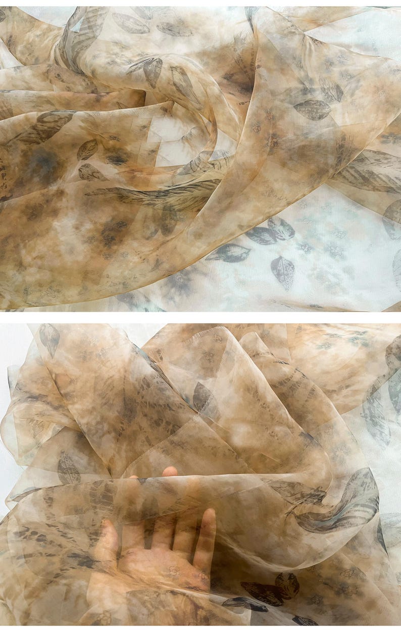 May include: A sheer, brown fabric with a delicate leaf pattern. The fabric is translucent and has a soft, flowing texture.