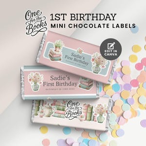 May include: Mini chocolate labels for a 1st birthday, featuring a floral and book theme. The labels are pink and blue, with the text "Sadie's First Birthday". The image also includes the text "One for the Books" and "Edit in Canva".