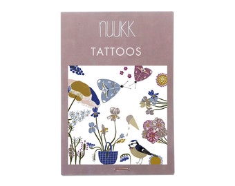 May include: A sheet of temporary tattoos featuring a bluebird, butterflies, flowers, and a small potted plant. The sheet is pink with the text "NUUKK TATTOOS" printed at the top.