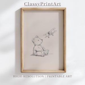 May include: A framed print featuring a sketch of a teddy bear and a biplane. The bear is seated, looking up at the plane. The print has the text "ClassyPrintArt" at the top and "HIGH-RESOLUTION | PRINTABLE ART" at the bottom.