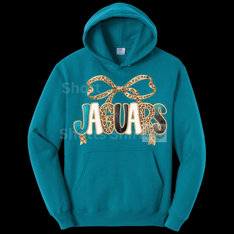 May include: Teal hooded sweatshirt with the word "JAGUARS" in a white, black, and leopard print design. A leopard print bow is above the word. The sweatshirt has a front pocket and a drawstring hood.
