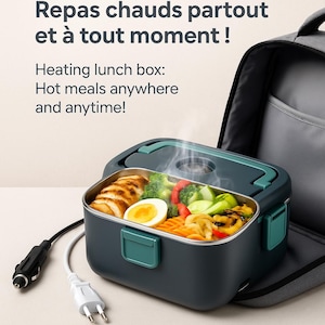 May include: A dark teal heating lunch box with a stainless steel interior, filled with cooked food. The lid and handle are teal. The text reads: "Heating lunch box: Hot meals anywhere and anytime!" A car charger and a wall plug are visible.