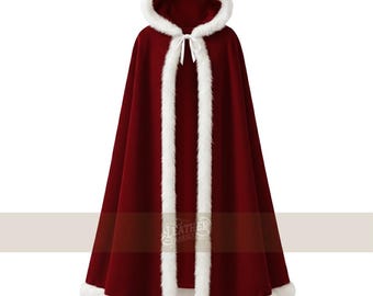May include: A burgundy hooded cloak with white faux fur trim. The cloak features a hood and a tie closure at the neck. The white trim accents the edges of the hood, front opening, and hemline. The cloak is made of a soft, flowing fabric.