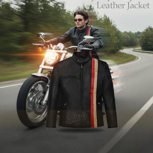 May include: Black leather jacket with a vertical red and tan stripe, inspired by Cyclops from X-Men. The jacket has a zipper closure and a stand-up collar. The image also shows a person riding a motorcycle on a road.