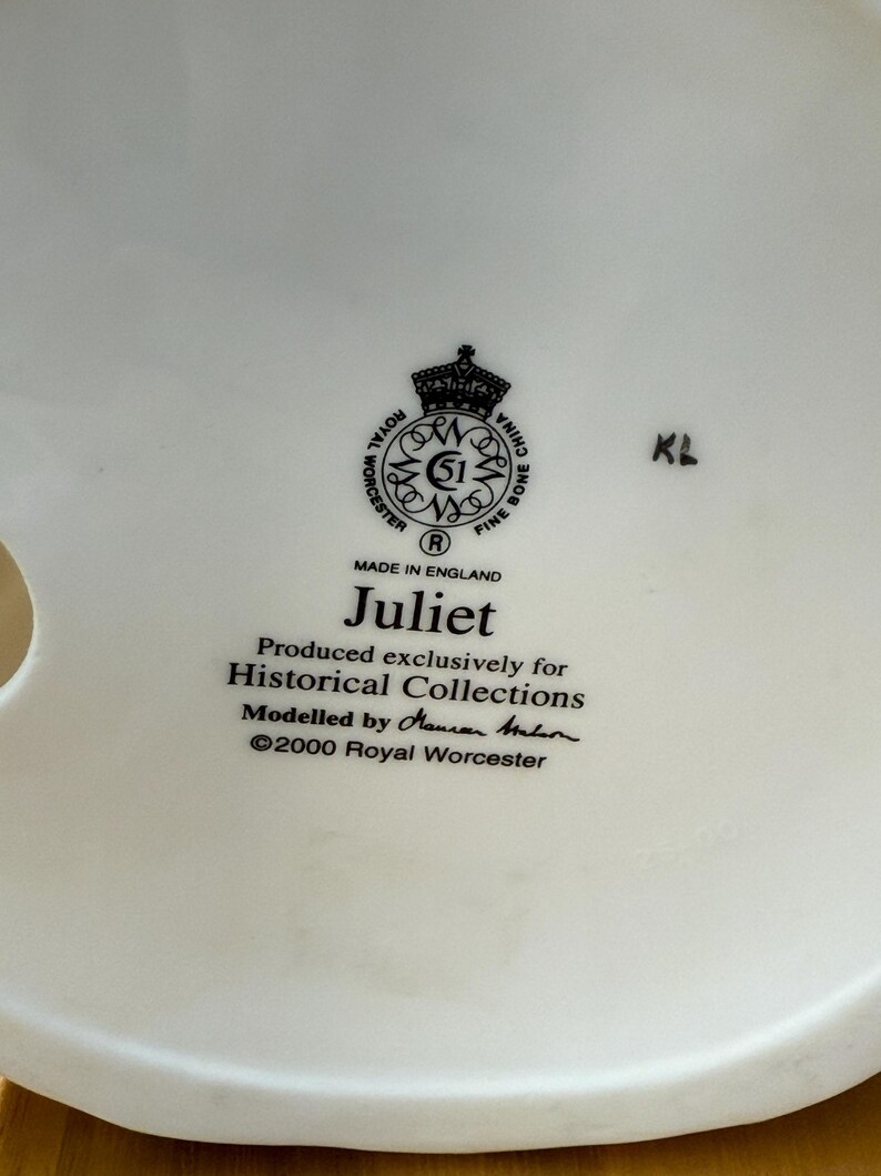 May include: Close-up of a white ceramic object with the Royal Worcester logo and the text "Juliet." The text also includes "Produced exclusively for Historical Collections" and "Made in England."