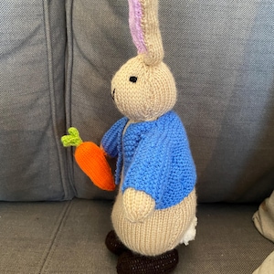 Hand knitted made Beatrix potter Peter Rabbit 25cm tall holding a carrot. Brand new