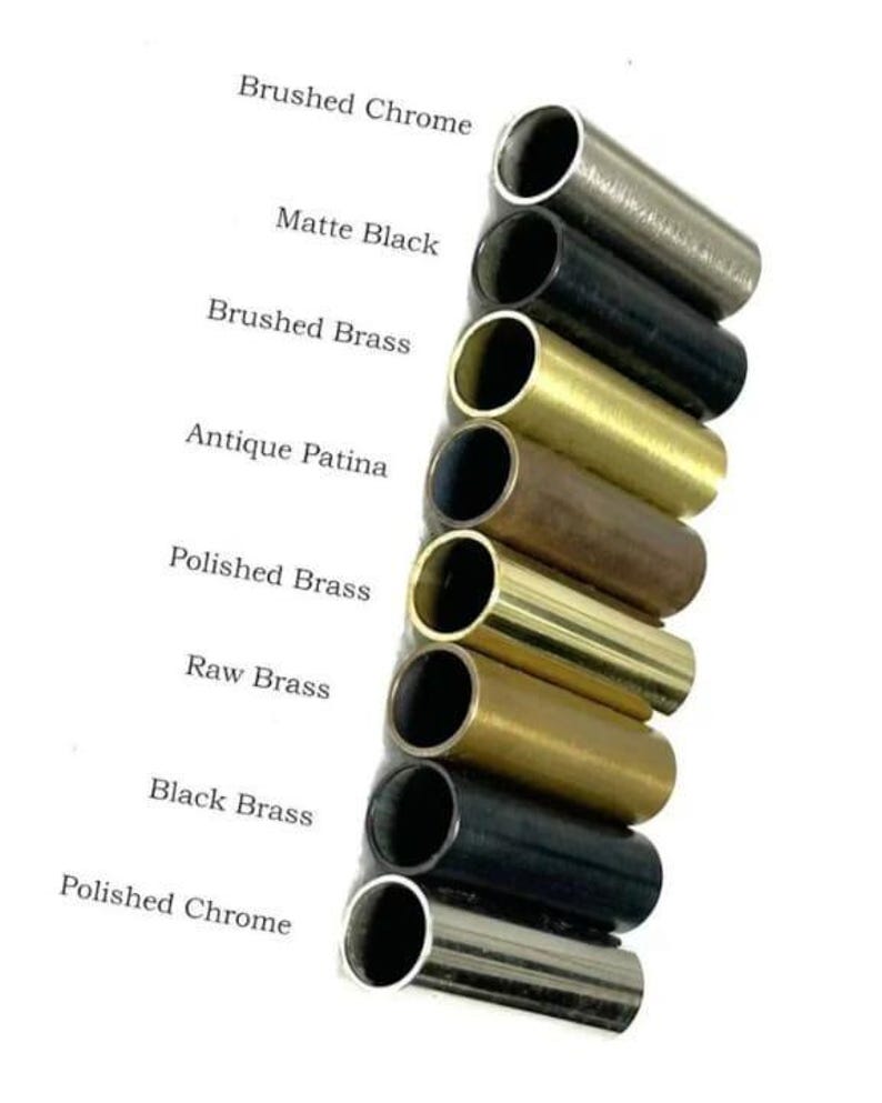 May include: A collection of metal tubes in various finishes, including Brushed Chrome, Matte Black, and Polished Brass. The image displays the different color options available, with text labels identifying each finish. The tubes are cylindrical and have a polished appearance.