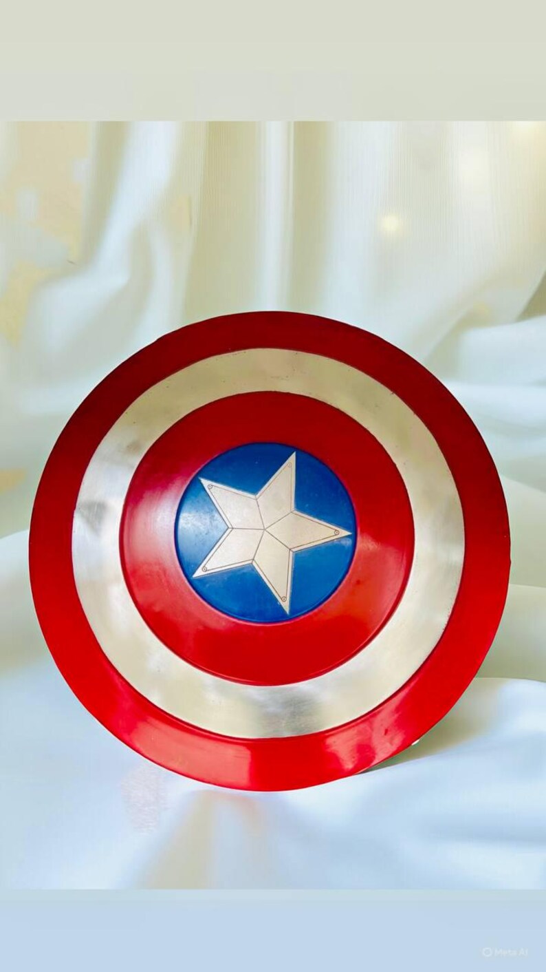 May include: A red, white, and blue Captain America shield. The shield has a red outer ring, a silver middle ring, and a blue center with a white star. This shield is a popular item for cosplay and superhero enthusiasts.