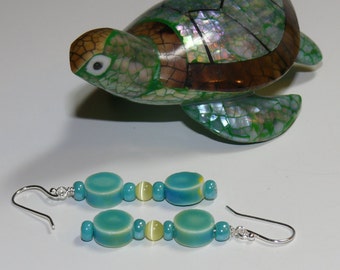 Ladies handmade earrings with ceramic aqua disk beads with a round yellow center glass bead with sterling silver earwires