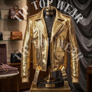 May include: A gold, snakeskin-textured leather jacket with a classic biker style. The jacket features a notched collar, asymmetrical zipper, and multiple pockets. The text "TIP TOP WEAR" is visible in the image.