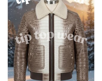 May include: A brown and white leather jacket with a shearling collar. The jacket has a zipper closure, two front pockets, and a ribbed hem and cuffs. The text "tip top wear" is visible in the image.