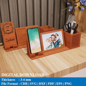 May include: A wooden desk tidy with a phone stand, photo frame, and pen holder. The light brown wood organizer has a personalized nameplate with the name "Zidan". The organizer is approximately 3-4 mm thick.