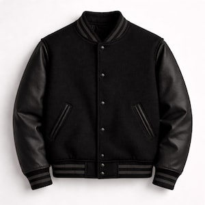 Könnte beinhalten: Schwarze Collegejacke mit schwarzen Lederärmeln. Die Jacke hat einen gerippten Kragen, Bündchen und Saum mit grauen Streifen. Sie hat eine Knopfleiste und zwei Vordertaschen.