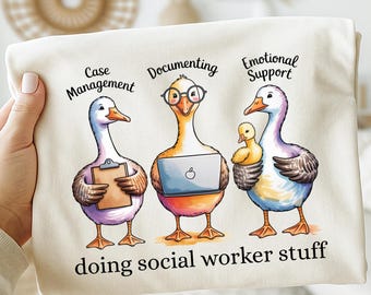 May include: A beige t-shirt featuring three cartoon geese, each representing a social worker role: Case Management, Documenting, and Emotional Support. The geese are depicted with a clipboard, laptop, and a baby chick. The text "doing social worker stuff" is at the bottom.