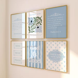 May include: A set of six rectangular wall art prints in thin gold frames. The prints feature light blue, white, and green color palettes with various religious text, floral illustrations, vertical stripes, and heart patterns on a light background.