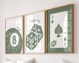 May include: Three framed art prints with a casino theme. The prints feature a green eight ball with the word "LUCKY", dice with the words "Feeling Lucky", and an ace of spades card. The prints have a distressed, vintage look.