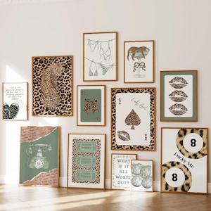 May include: A collection of framed art prints with a leopard print theme. The prints feature various designs, including a leopard, playing cards, lips, and text. The color palette includes brown, green, and white.