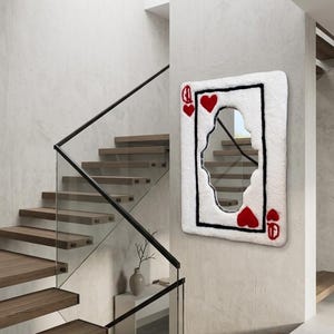 May include: A rectangular wall mirror featuring a white tufted border designed to resemble a playing card. The mirror includes a black rectangular outline, two red heart symbols in the corners, and stylised red queen letter Q markings.