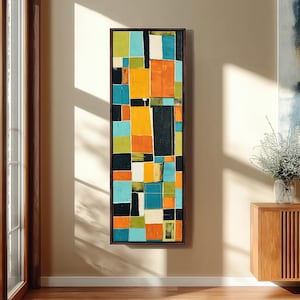 May include: A tall, rectangular framed wall art piece featuring a grid of abstract geometric blocks in vibrant shades of orange, turquoise, lime green, black, and white. The composition consists of varied vertical and horizontal rectangles.