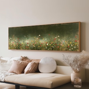 May include: A panoramic rectangular wall art piece featuring an oil painting of a wildflower meadow against a dark olive green background. The artwork is encased in a light-coloured wooden frame and displays various small red, yellow, and white flowers.