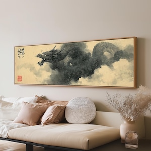 May include: A rectangular wall art piece featuring a black ink-style dragon emerging from dark, swirling clouds against a light beige background. The artwork includes black calligraphic text on the left and a small red square seal stamp below it.