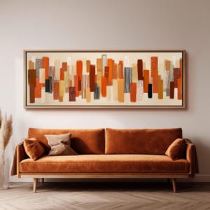May include: A rectangular wall art piece featuring a series of vertical, abstract rectangular shapes in shades of orange, brown, cream, and black. The composition includes solid blocks of colour alongside textured patterns and thin vertical lines.