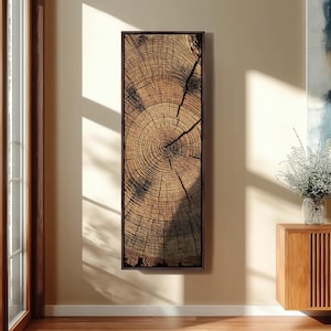 May include: A tall, rectangular wall art piece featuring a high-resolution print of a tree trunk cross-section. The image displays detailed brown and tan concentric growth rings, natural wood grain textures, and a prominent dark crack running through.
