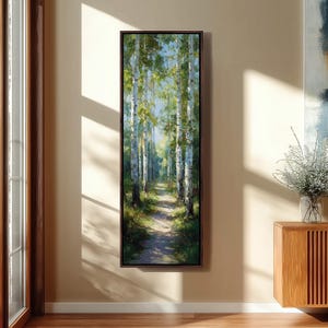 May include: A framed vertical landscape painting shows a path through a birch forest. The artwork features tall trees with white bark and green leaves, creating a sense of depth and tranquility. The path is a light brown colour.