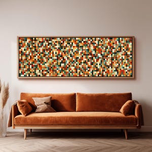 May include: A rectangular wall art piece featuring a dense grid of small, multi-colored square tiles in shades of red, orange, yellow, teal, and white, enclosed within a simple light-toned wooden frame and mounted horizontally.