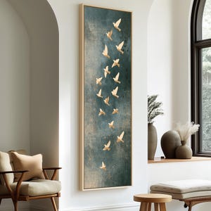 May include: A tall, rectangular framed wall art piece featuring a textured, dark teal and blue background. The artwork displays a vertical arrangement of numerous small, light-colored bird silhouettes flying upward in a scattered, flowing formation.