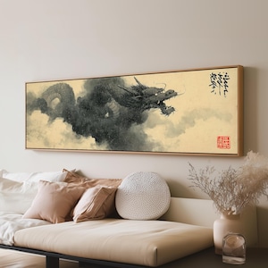 May include: A rectangular wall art piece featuring a black ink-style dragon emerging from dark clouds against a cream-colored background. The artwork includes black calligraphy in the upper right corner and a small red square seal in the lower right.