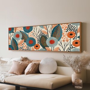 May include: A rectangular wall art piece in a wooden frame featuring a repeating pattern of stylised flowers and leaves in shades of teal, orange, and cream. The design includes circular floral shapes, pointed foliage, and black dotted textures.