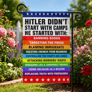 May include: A rectangular garden flag featuring a rainbow-colored background with white stars at the top and bottom. The text reads: HITLER DIDN'T START WITH CAMPS HE STARTED WITH: BANNING BOOKS, TARGETING THE PRESS, BLAMING IMMIGRANTS, AND MORE.