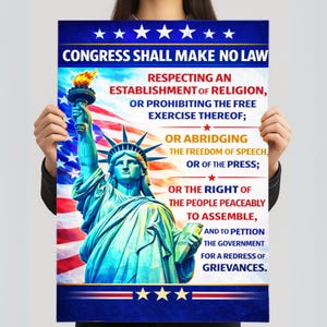 May include: A poster depicting the Statue of Liberty with the text "CONGRESS SHALL MAKE NO LAW" and the First Amendment. The background shows the American flag. The statue is holding a torch and a tablet.