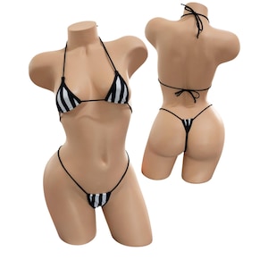 May include: A black and white striped bikini set displayed on a mannequin. The bikini top is a triangle style with halter straps, and the bottom is a thong style. The set is shown from the front and back.
