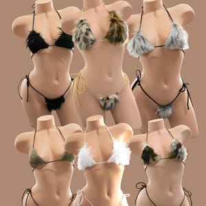 May include: Six bikini sets displayed on mannequins, each featuring triangle tops and thong bottoms made of faux fur. The sets come in solid black, white, and olive green, as well as leopard, grey, and brown-toned animal print patterns with ties.