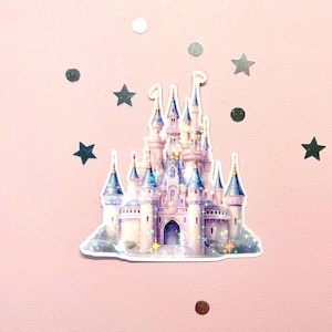 May include: A sticker of a fairytale castle with multiple turrets and a blue roof. The castle is white and pink with holographic accents. The sticker is surrounded by silver stars and circles on a pink background.