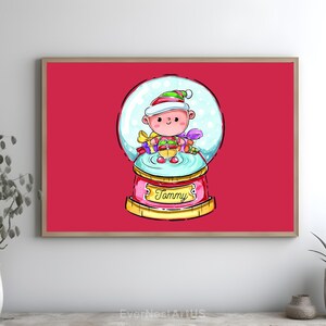 May include: A framed print featuring a cartoon snow globe with a character inside. The character wears a green and red hat, scarf, and holds gifts. The snow globe sits on a pink base with the name "Tammy". The background is red.
