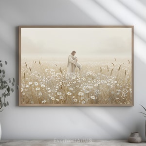 May include: A framed print depicts a figure in a long robe holding a lamb in a field of white flowers and tall grass. The artwork has a soft, muted color palette with a warm, inviting feel. The print is in a light brown wooden frame.