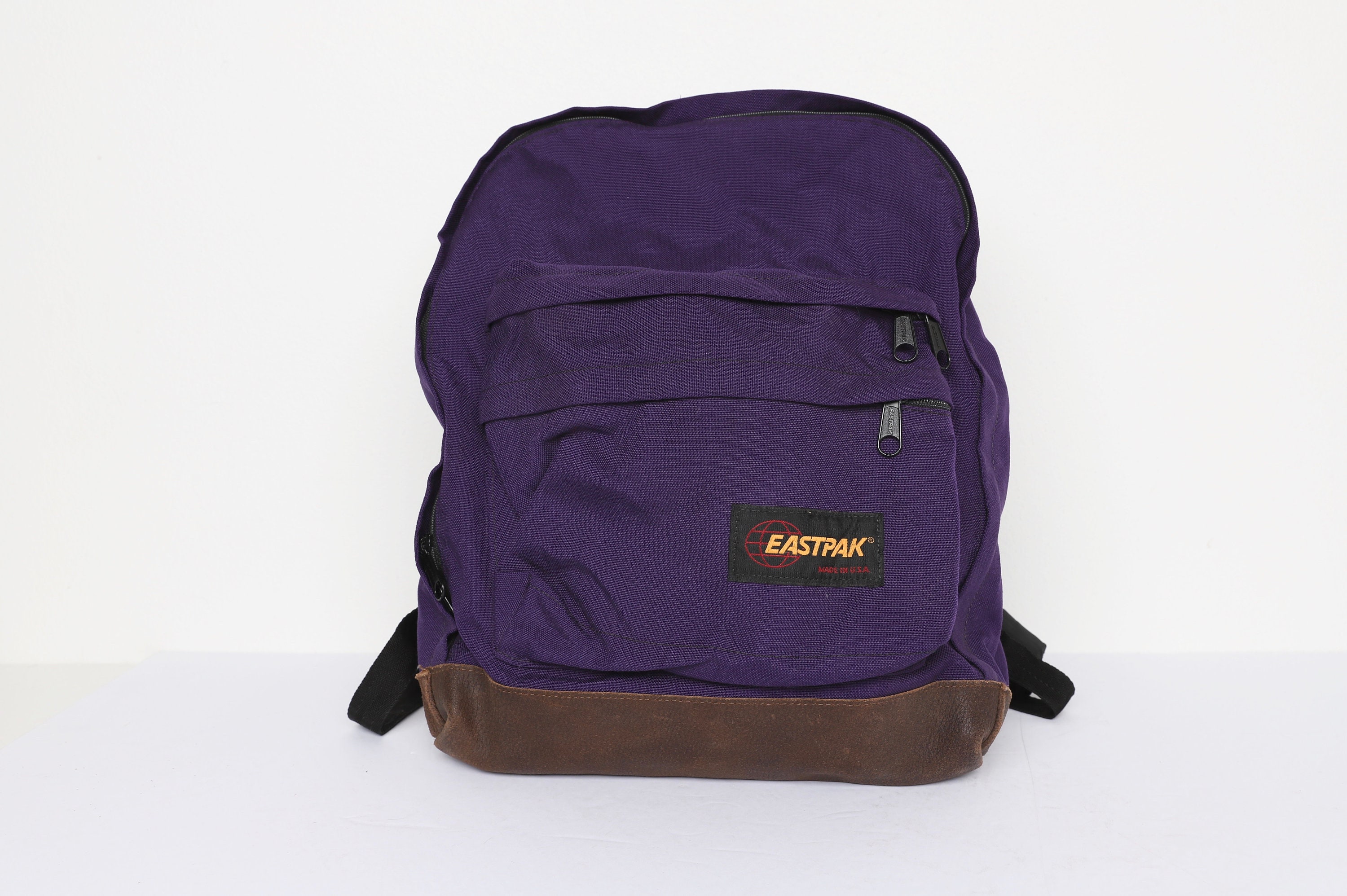 eastpak backpack leather bottom