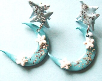 New Moon and Stars dangle women's earrings in blue and white with silver glitter 2 in. long lightweight polymer clay.  Very stylish.