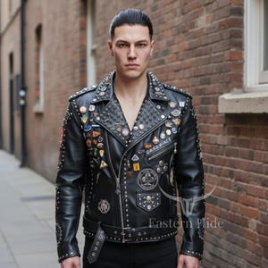 May include: Black leather jacket with silver studs and decorative pins. The jacket has a classic biker style with a notched collar, asymmetrical zipper, and a belt at the waist. The text "CRAZY-ACE" is visible on the front.