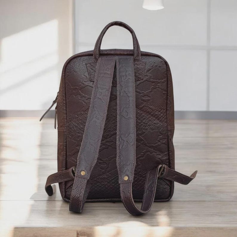 Strap View: "Close-up of the adjustable leather shoulder straps, designed for comfort and easy carrying.