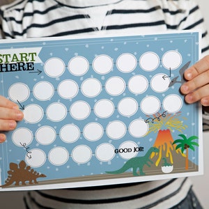 May include: A blue and white dinosaur themed printable chart with circles to fill in. The chart says "Start Here" and "Good Job!" with a dinosaur and volcano illustration.
