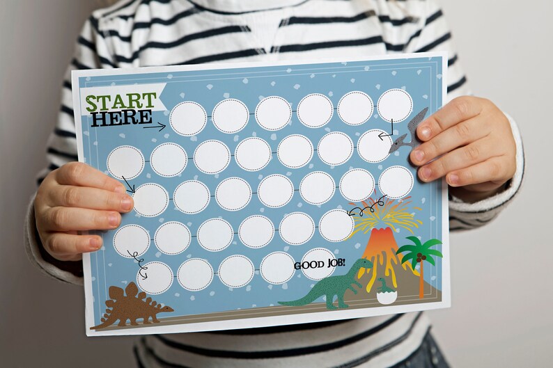 May include: A blue and white dinosaur themed printable chart with circles to fill in. The chart says "Start Here" and "Good Job!" with a dinosaur and volcano illustration.